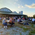 Sun setting behind Caesar Creek Vineyard's barn at Raise a Glass to Reading event