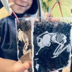 child with clear plastic planter she created