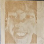 laser engraving of child wearing tiny sunglasses