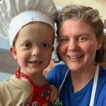 Child in chef hat with mom