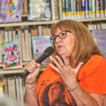 Sally speaks into the microphone about supporting other families