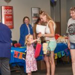 young girl looks through goodie bag