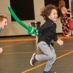 boy running with balloon sword