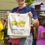 woman shows off summer reading tote bag