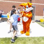 Booker the Fox mascot high-fives boy