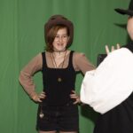 teen poses at green screen