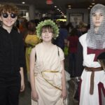 three dressed up teens pose