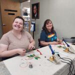Two patrons enjoying stained glass class