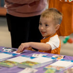 young boy picking out a sticker