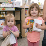 two young girls pose with snack bags