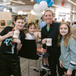 family poses with their "See Ya at Xenia" mugs