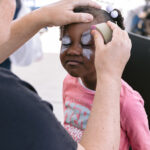 young girl getting face painted