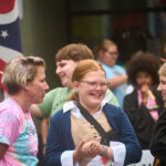 teens dressed in colonial garb and Harry Potter costumes wait to enter