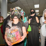 costume contest winners in dino mask holding prize basket