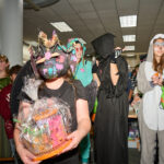 costume contest winners in dino mask holding prize basket