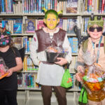 costume contest winners posing and holding their prize baskets