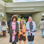 3 teens dressed as anime characters posed outside the library entrance