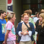 teens dressed in colonial garb and Harry Potter costumes wait to enter