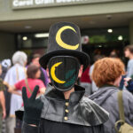 teen with digital mask and moon top hat