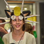 Teen girl dressed as Meowth from Pokemon