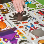 teen choosing spooky stickers to decorate a bag