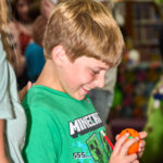 teen opening up a plastic egg