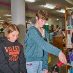 teens making mini buttons
