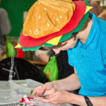 teen in hamburger hat browsing stickers