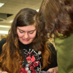 two teens swapping trading cards