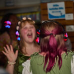 Teen girls sing along during silent disco