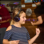 young teen dancing with headphones on