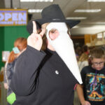 Teen dressed as plague doctor does peace sign