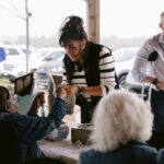 woman purchasing raffle tickets