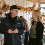 man and staff volunteer talking