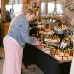 woman making a plate from the charcuterie food display