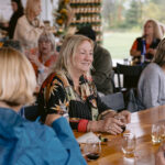 woman smiling and holding wine