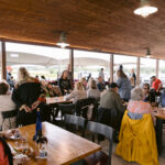 wide shot of people sitting at tables