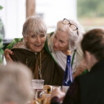 two women side hugging