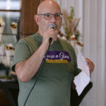 Executive Director Karl Colón speaking into microphone