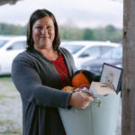 auction winner holding her prize basket