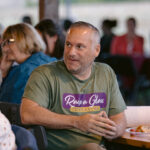 Staff volunteer Mike T sitting