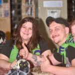 couple smiling at camera man giving thumbs up
