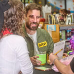 man holding drink and smiling