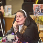 woman dressed as a nun contemplating