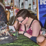 woman writing on trivia sheet