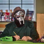 Masked patron writing down trivia answers