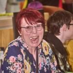 red haired patron laughing
