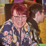 red haired patron laughing