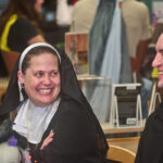 patron dressed as nun smiling