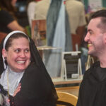 patron dressed as nun smiling